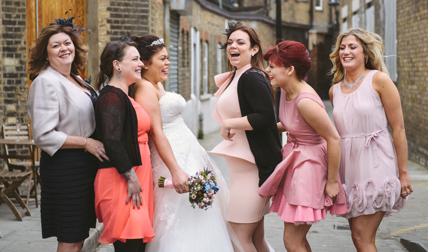 bride and bridesmaids at warehouse wedding